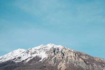 Snow-Capped Mountain Peak Against Clear Blue Sky