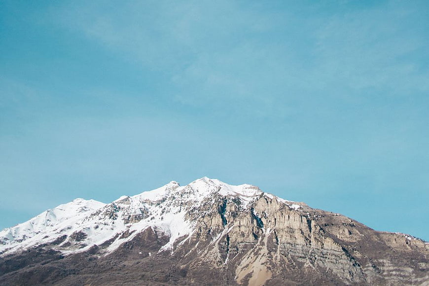 Snow-Capped Mountain Peak Against Clear Blue Sky