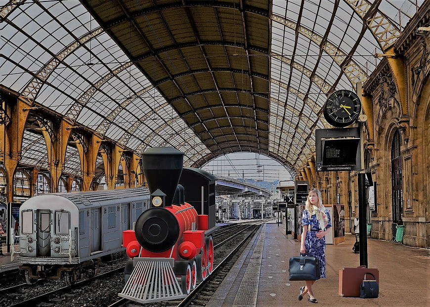 Woman with vintage luggage at historic train station platform