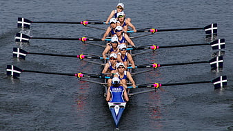 Women's Rowing Eight Team Racing On Calm Water