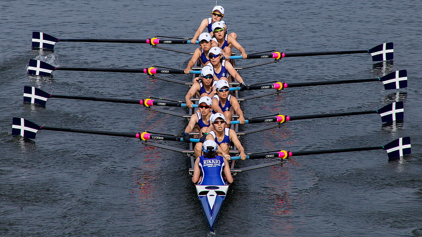 Women's Rowing Eight Team Racing On Calm Water