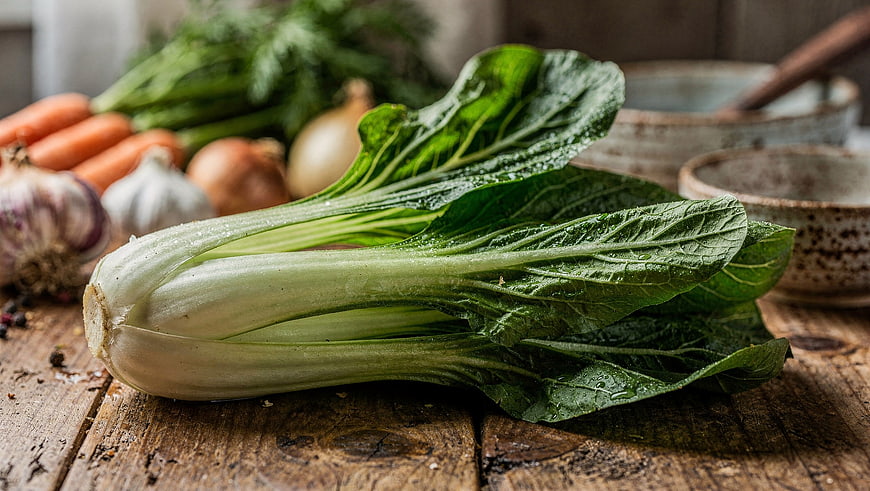 Fresh Bok Choy on Rustic Wooden Table with Vegetables