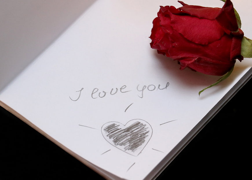 Red Rose on Notebook Page with Handwritten I Love You