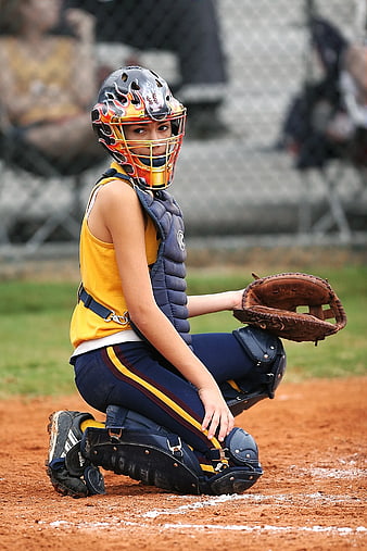 Young Female Softball Catcher Kneeling on Dirt Field