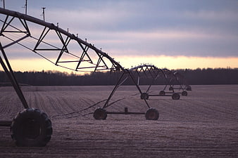Center Pivot Irrigation System in Field at Sunset