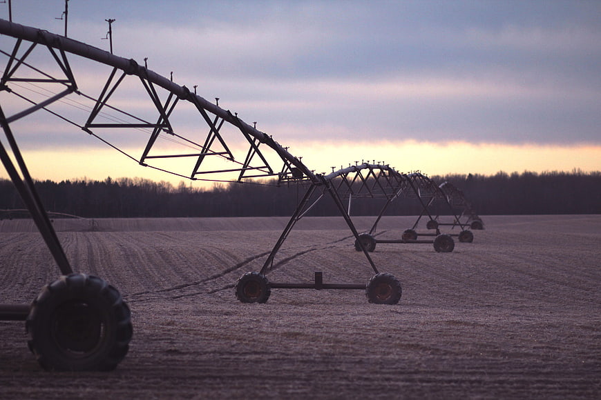 Center Pivot Irrigation System in Field at Sunset