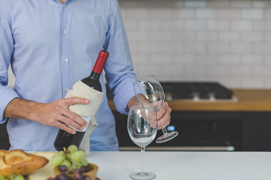Man Pouring Red Wine in Modern Kitchen