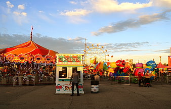 Carnival Ticket Booth And Carousel At Dusk