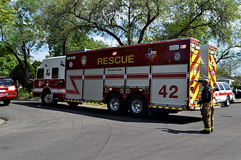 Fire Rescue Truck 42 Parked On Suburban Street With Firefighter