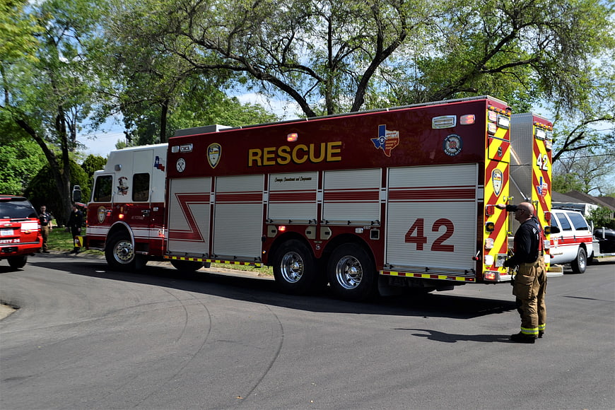 Fire Rescue Truck 42 Parked On Suburban Street With Firefighter