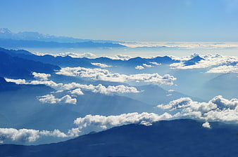 Majestic Himalayan mountain range with clouds and sunbeams