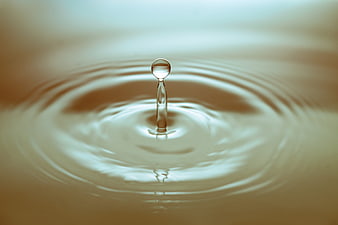 Macro Water Droplet Splash with Ripples and Reflection