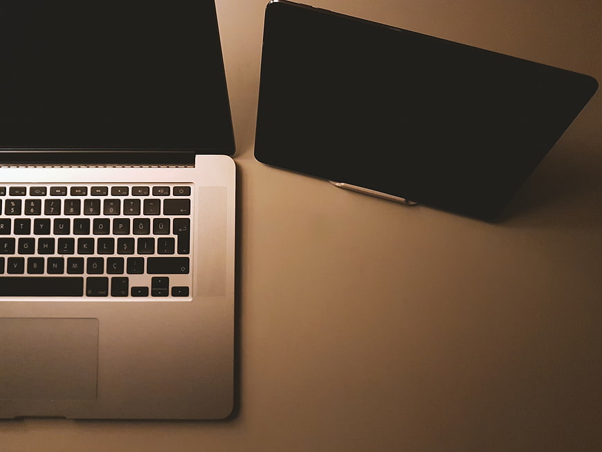 Top View of Laptop and Tablet on Desk