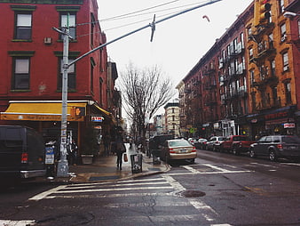 Wet Brooklyn Street Scene with Red Brick Buildings and Cars