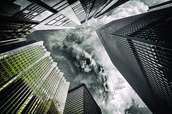 Dramatic low-angle view of skyscrapers with lightning storm
