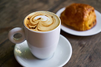 Latte Art Coffee Cup with Croissant on Wooden Table