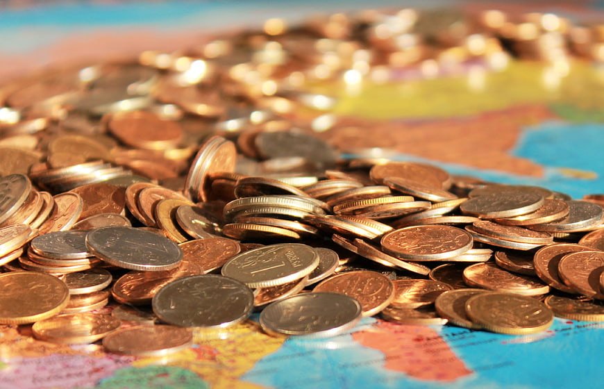 Pile of Russian Ruble Coins on a World Map