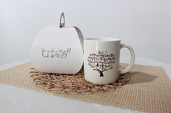 White Ceramic Mug And Gift Box On Woven Placemat