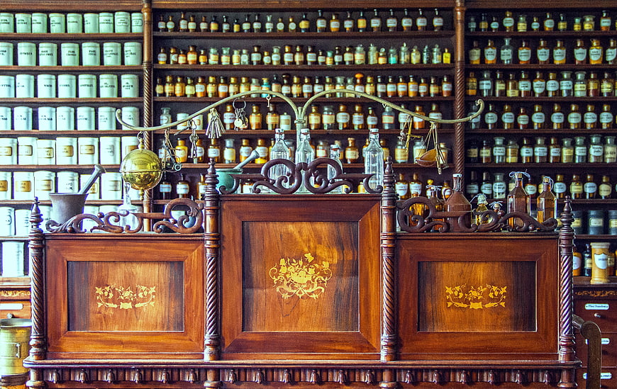 Historical Pharmacy Counter with Antique Bottles and Wooden Inlays