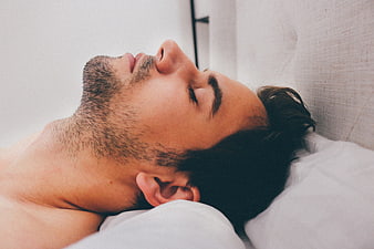 Young Man Sleeping Peacefully On White Pillow