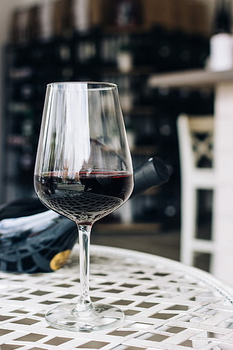 Glass of red wine on white metal table