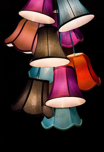 Colorful Hanging Lampshades Against Black Background