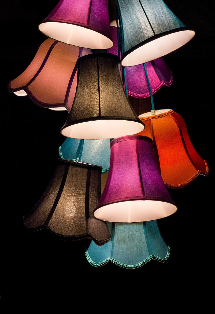 Colorful Hanging Lampshades Against Black Background