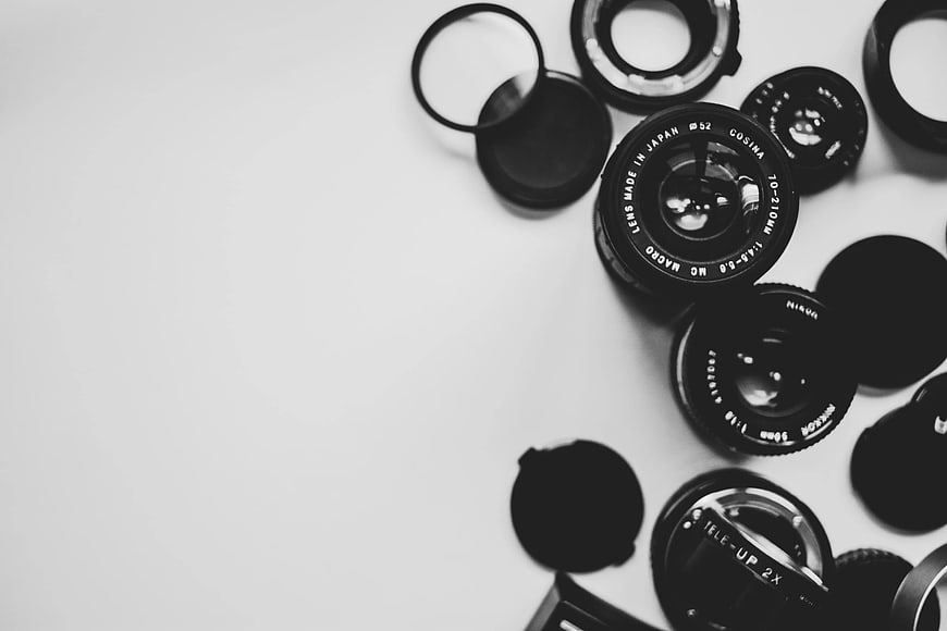 Black and White Camera Lenses Flat Lay on White Background