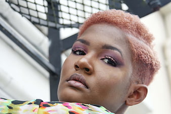 Portrait of woman with pink hair and purple makeup