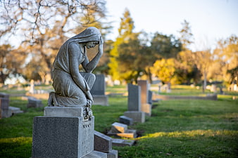Mourning Woman Statue in Cemetery at Golden Hour