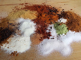 Assorted Ground Spices And Herbs On Wooden Surface