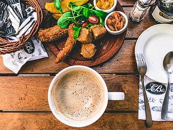 Overhead view of coffee and breakfast platter on rustic wooden table