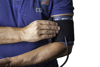Man Checking Blood Pressure with Monitor Cuff