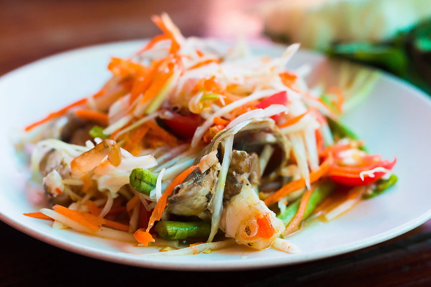 Thai Papaya Salad with Fish Head on White Plate