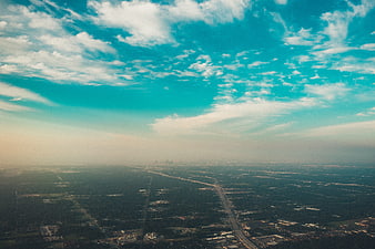 Aerial View of City Skyline with Vibrant Blue Sky and Clouds