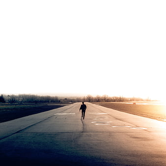 Man Running on Empty Runway at Golden Hour