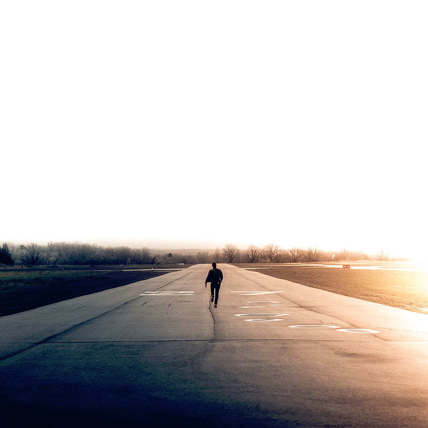 Man Running on Empty Runway at Golden Hour