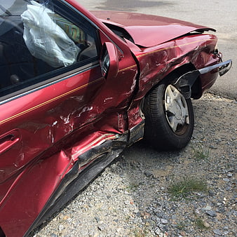 Red Car Accident Damage with Deployed Airbag