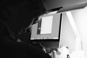 Woman working on computer in black and white