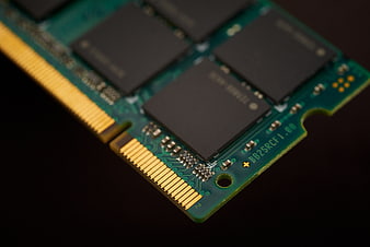 Close-up of green RAM stick with gold contacts