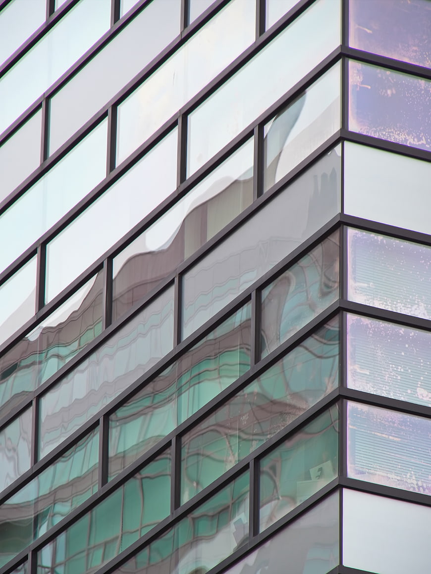 Modern Glass Building Facade with Abstract Reflections