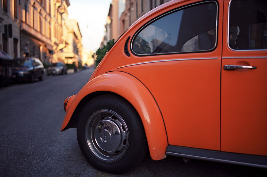 Close-up of Vintage Orange Volkswagen Beetle on City Street