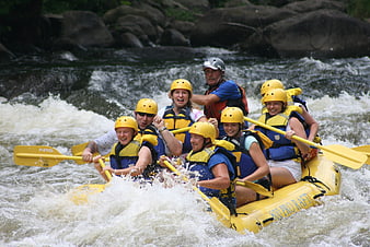 Group of people rafting in whitewater rapids