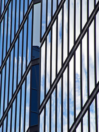 Modern Glass Building Facade with Blue Sky Reflection