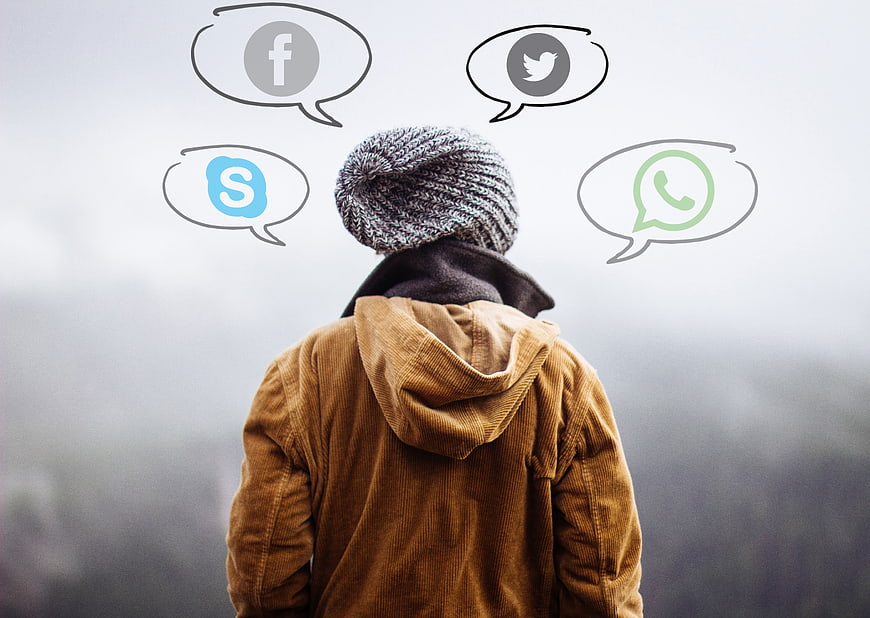 Person with social media icons in thought bubbles
