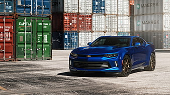 Blue Chevrolet Camaro Muscle Car Parked In Front Of Shipping Containers