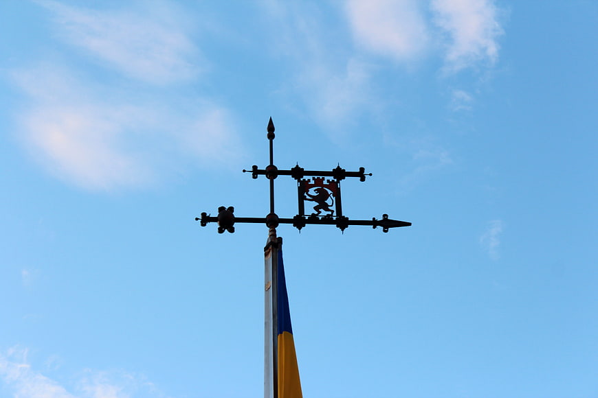Ukrainian Flag Finial with Lion Emblem Against Blue Sky