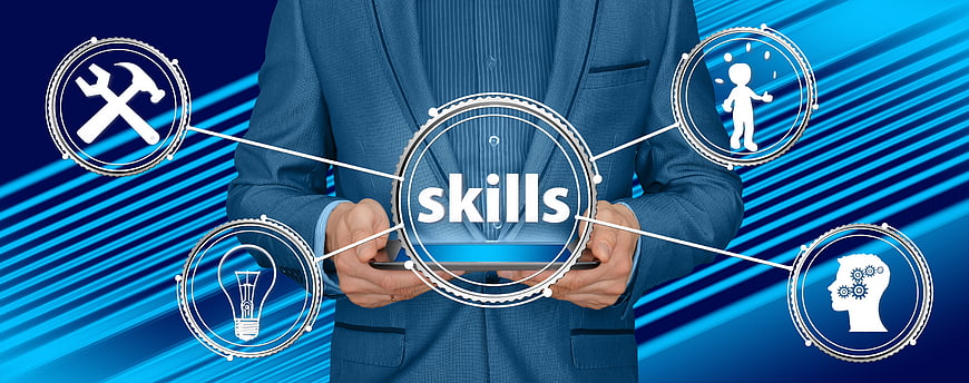 Businessman holding tablet with skills concept icons