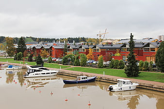 Harbor with boats and red wooden houses in autumn