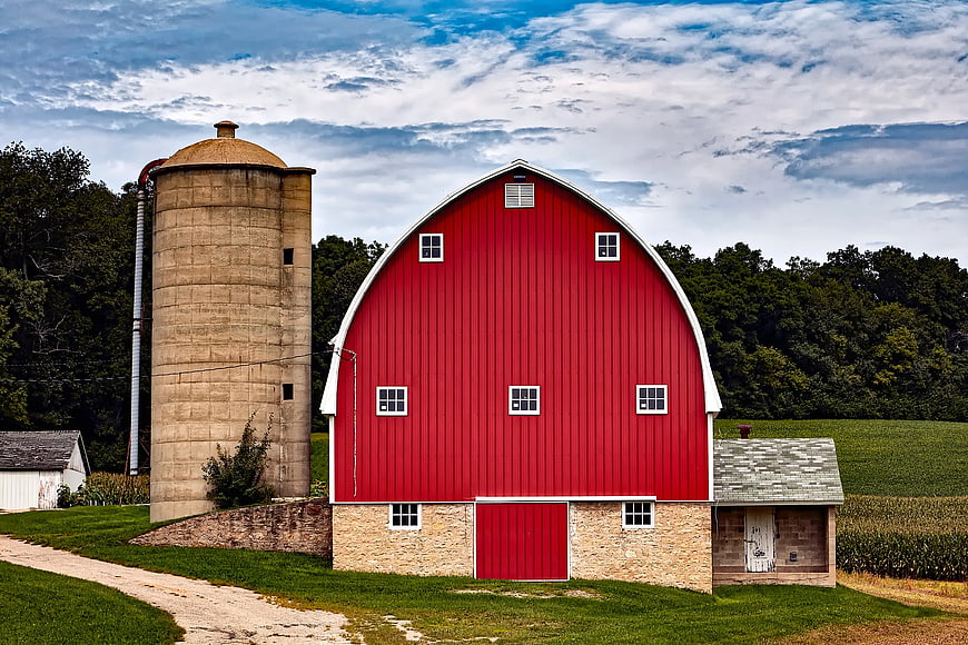 Classic Red Barn and Silo on Rural Farm Landscape
